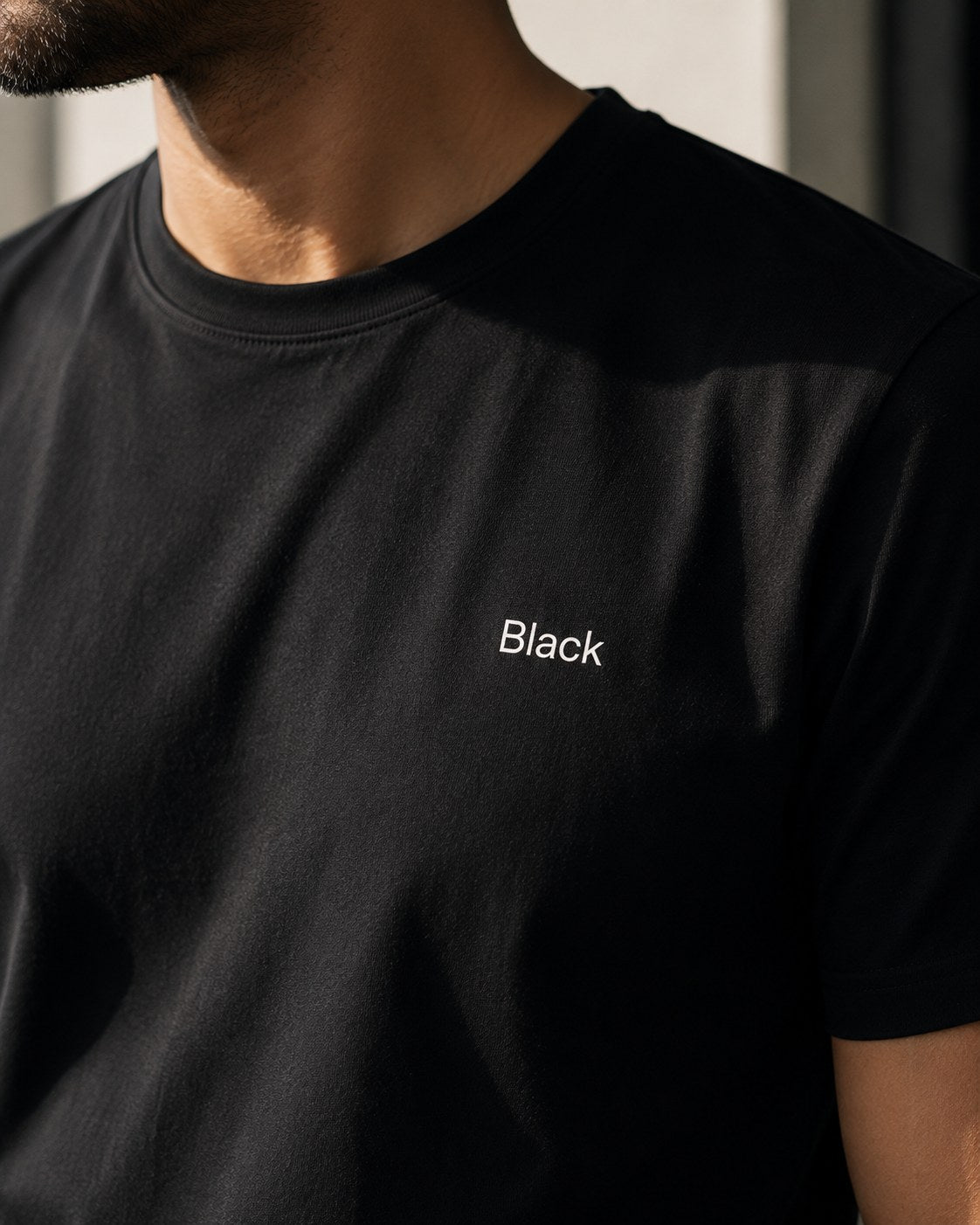 Close-up of the Black wordmark on the chest, worn