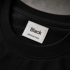 Neck label reading Black, 100% Suvin Cotton
