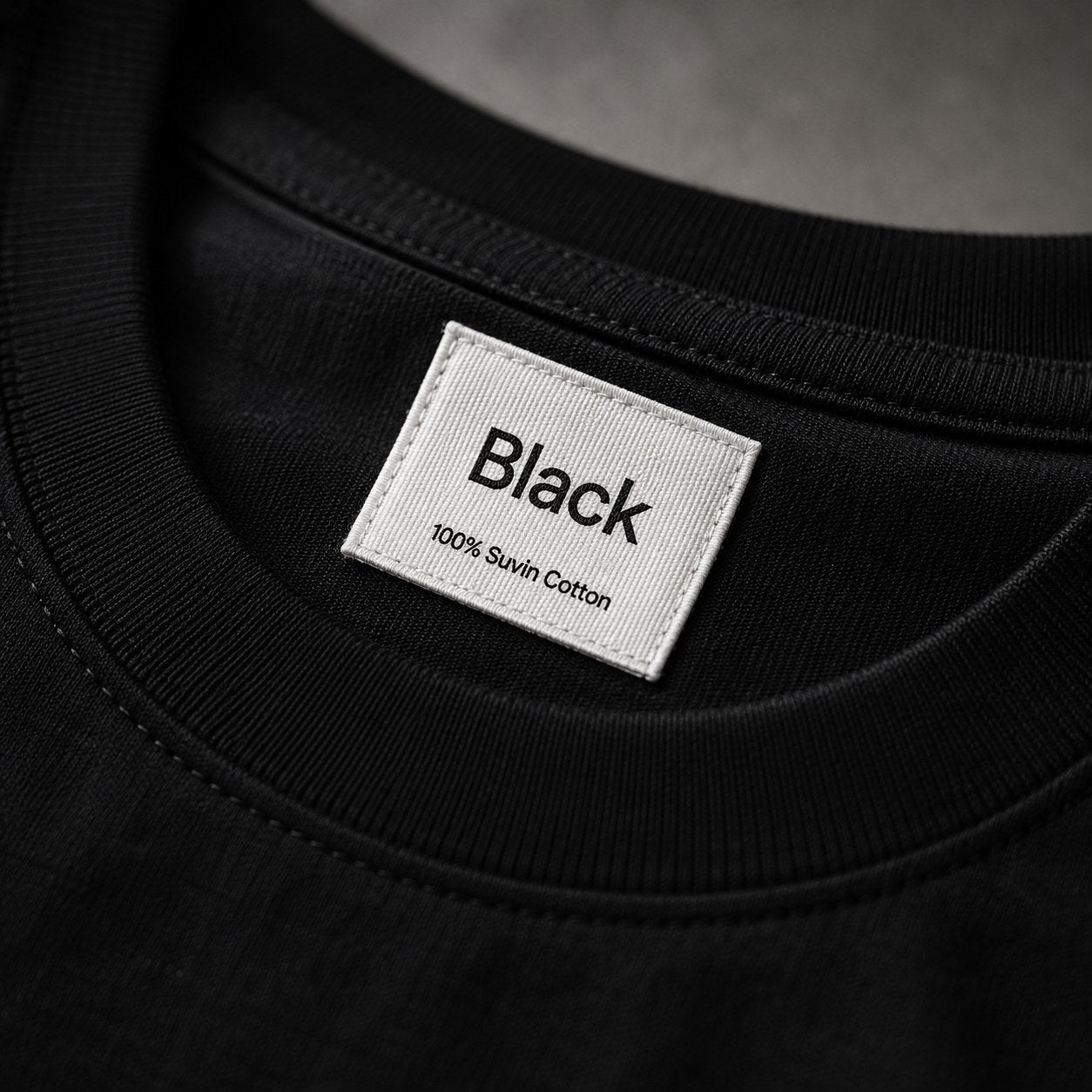 Neck label reading Black, 100% Suvin Cotton